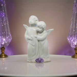 A Pair of Ceramic White Child Angels Singing &  Holding Songbook.‎ 6.75 inches